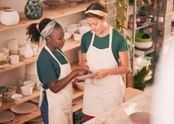 Pottery business and team check quality of sculpting together for creative process and productivity in workshop. Focus, concentration and talent of interracial colleagues in professional workspace